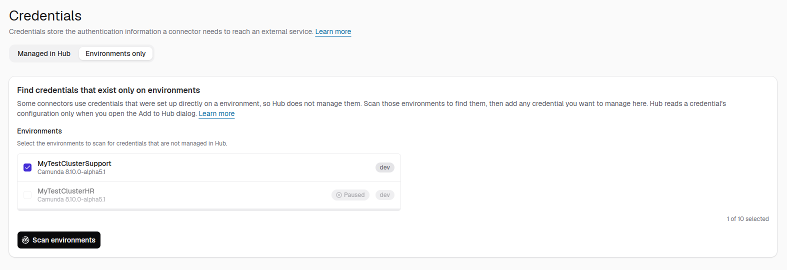 Environments only tab of the Credentials page, with one environment selected, a paused environment that can't be selected, and a Scan environments button